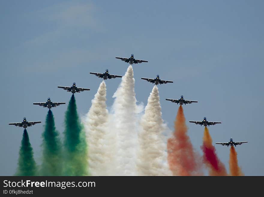 Frecce Tricolori flying in V formation and leaving Italian flag colored smoke trails.