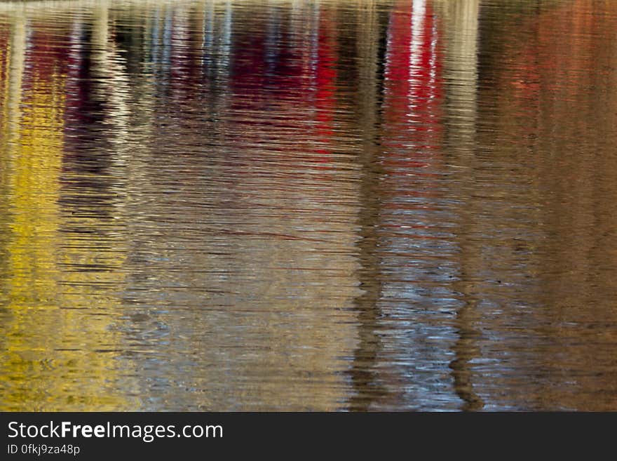 Autumn foliage colors reflected on lake surface. Autumn foliage colors reflected on lake surface.