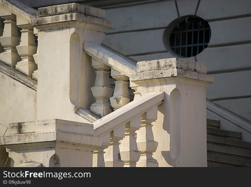 Warm sunset light on stone staircase of a palace.