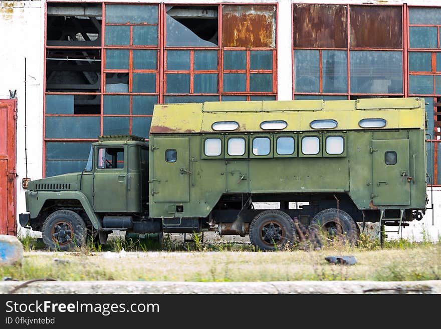 Rusy truck abandoned near a desolate run down building in a bust industrial zone. Rusy truck abandoned near a desolate run down building in a bust industrial zone.