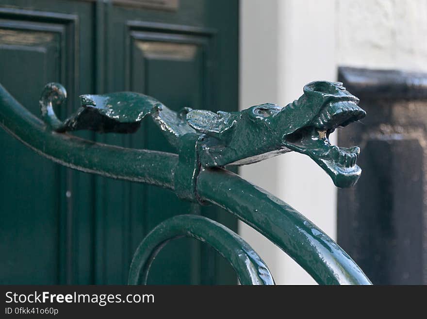 Decorative dragon head on a exterior staircase rail. Decorative dragon head on a exterior staircase rail