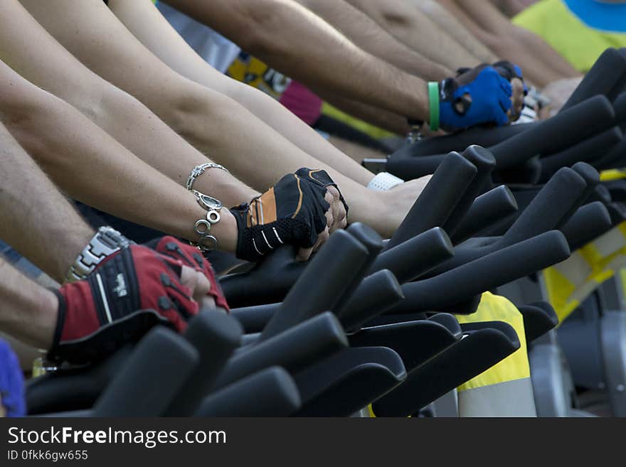 People lined up on exercise bikes at a fitness session.