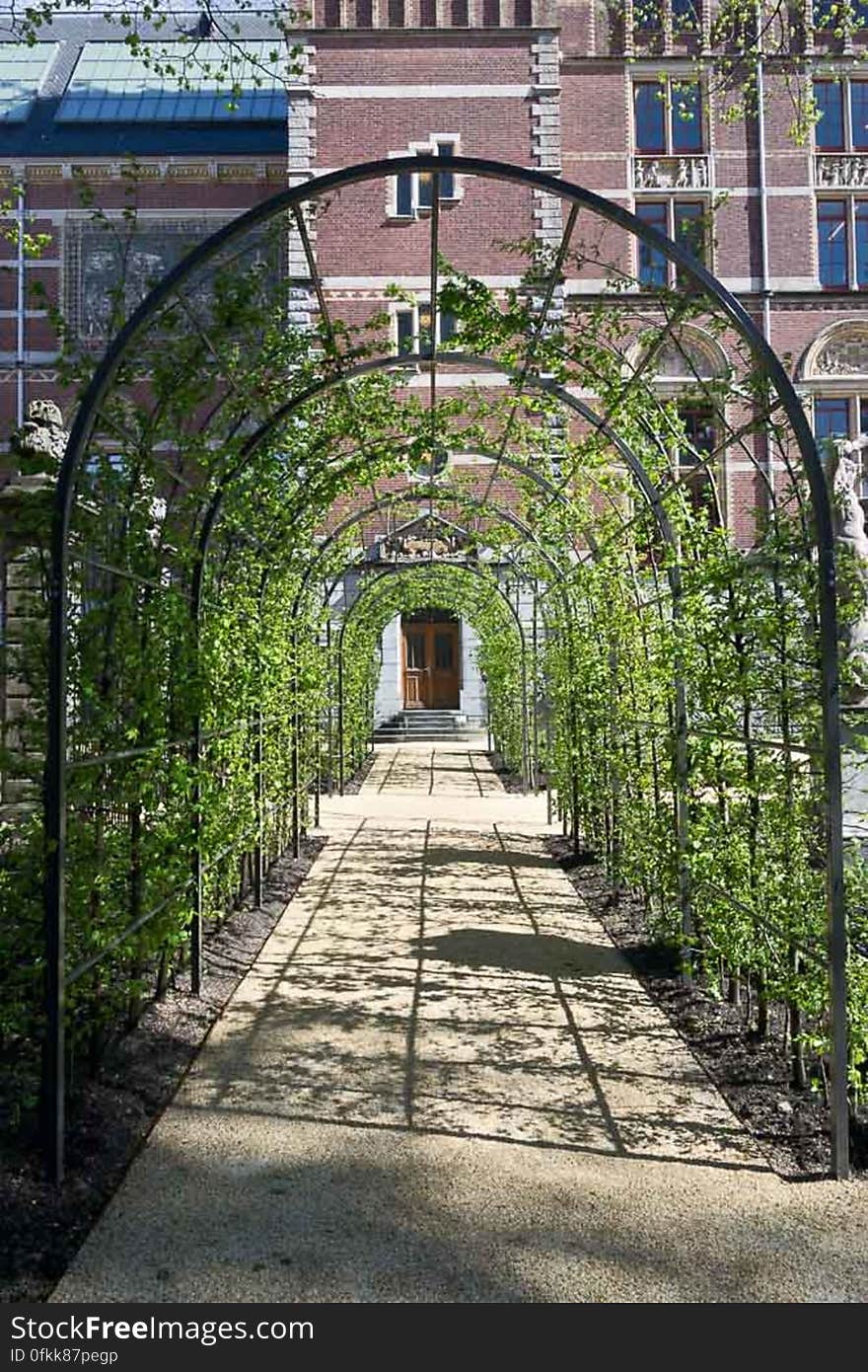 Latticework pergola leading to a museum library