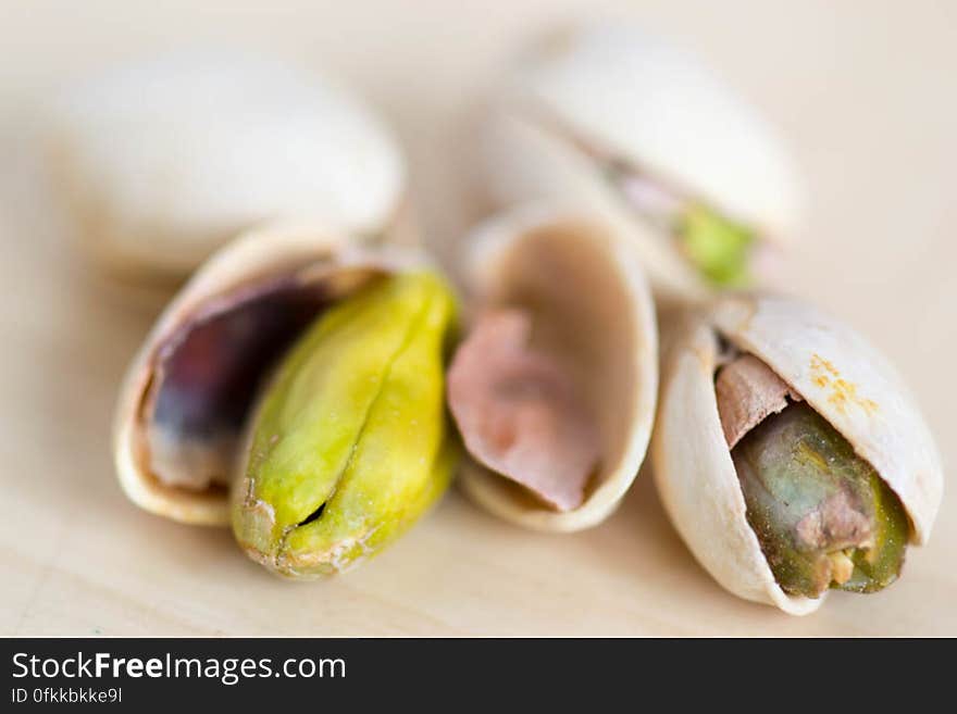 A macro shot of green colored roasted pistachios seed out of shells. A macro shot of green colored roasted pistachios seed out of shells.