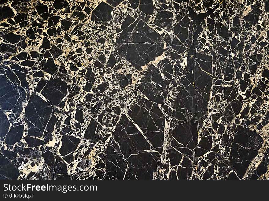 Polished table top made of Chinese black marble with white veins.