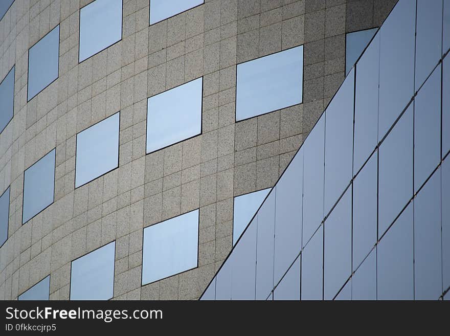 Curved office building in commercial area of a city. Sleek straight lines are combined with rounded shapes to create an amazing look.