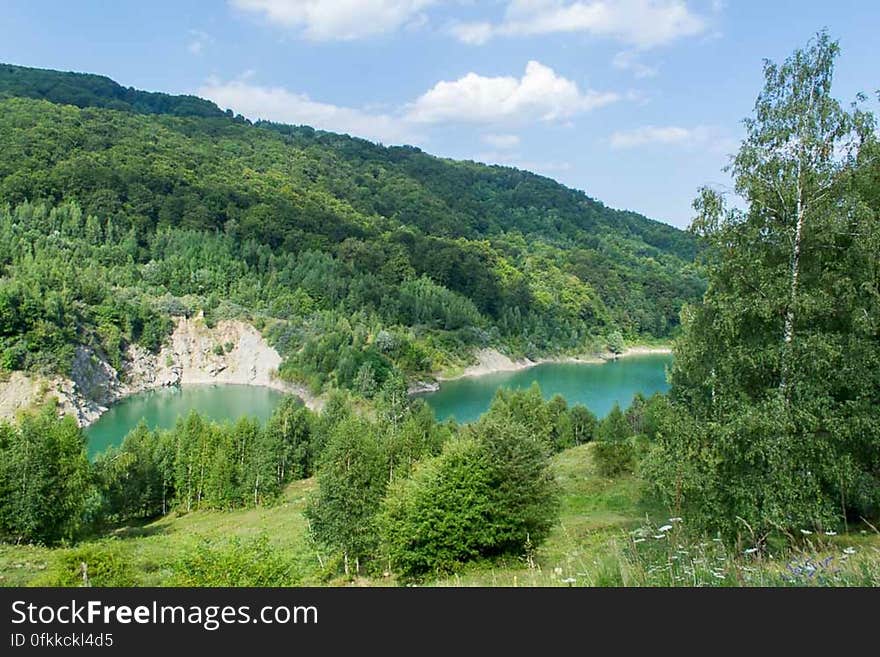 Reservoir with clear emerald water in a pitoresque location in the mountains. Reservoir with clear emerald water in a pitoresque location in the mountains.