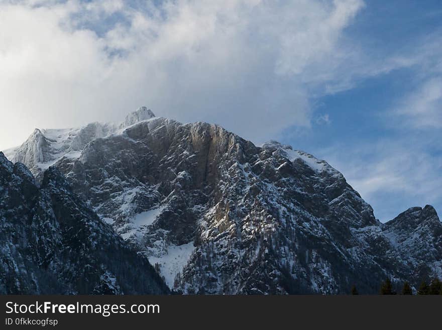 Snowy mountain ridge under mass of clouds. Snowy mountain ridge under mass of clouds.