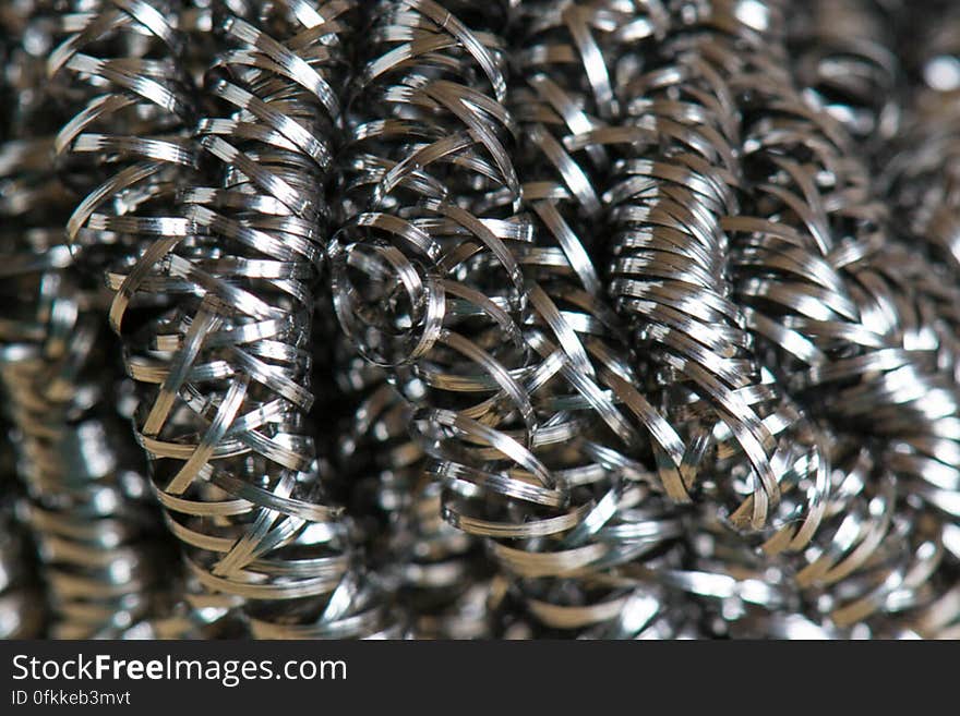 Close-up of a cleaning scrub metallic spirals used for doing dishes. Close-up of a cleaning scrub metallic spirals used for doing dishes.