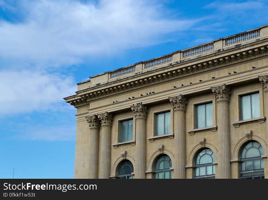 neoclassical-facade-against-blue-sky