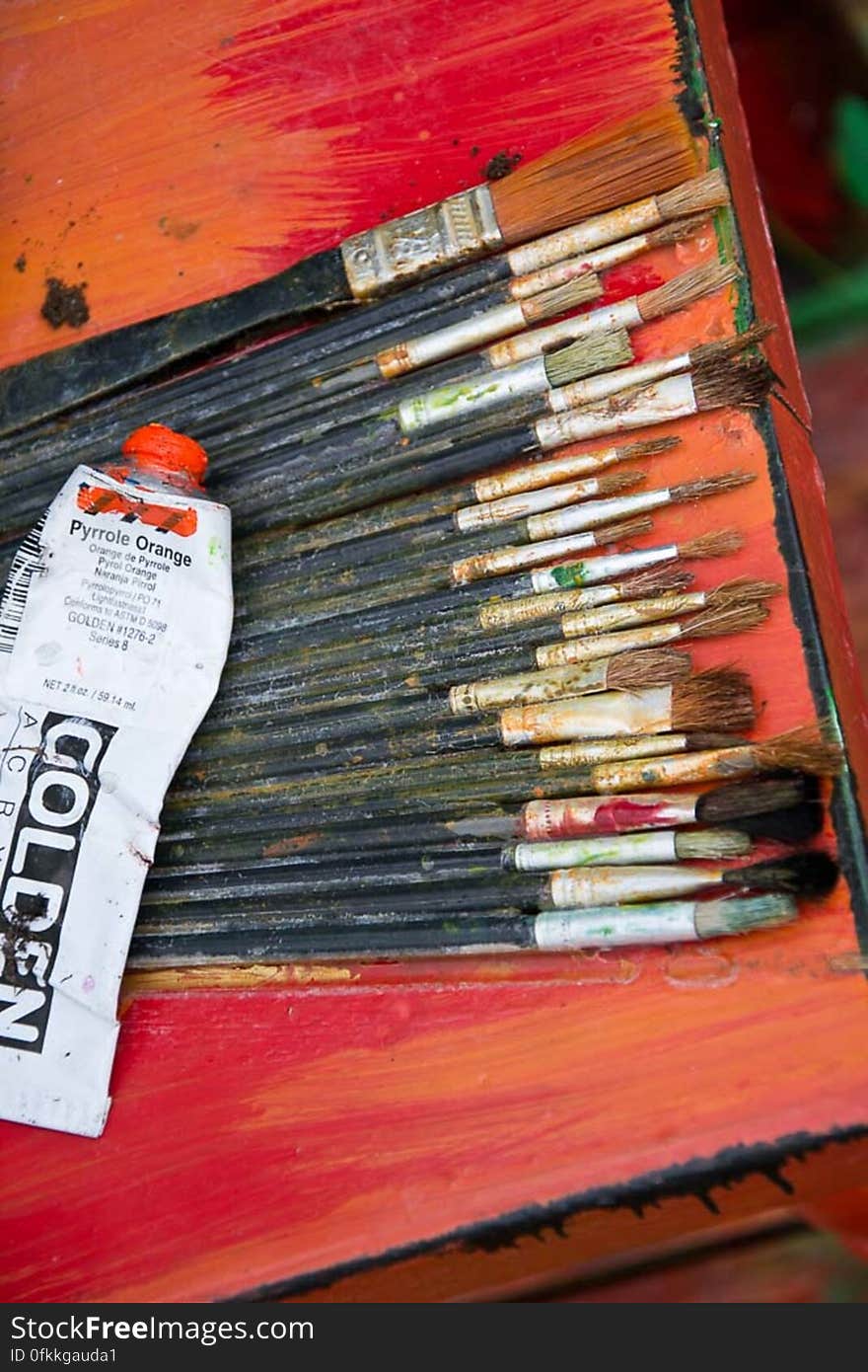 Painting brushes of different sizes used by artist with dried out acrylic paint on bristles. Painting brushes of different sizes used by artist with dried out acrylic paint on bristles.