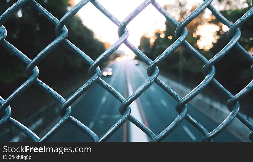 Streets seen through the fence on the overpass. Streets seen through the fence on the overpass.