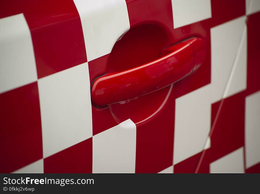 Picture of red and white squares livery on racing car.