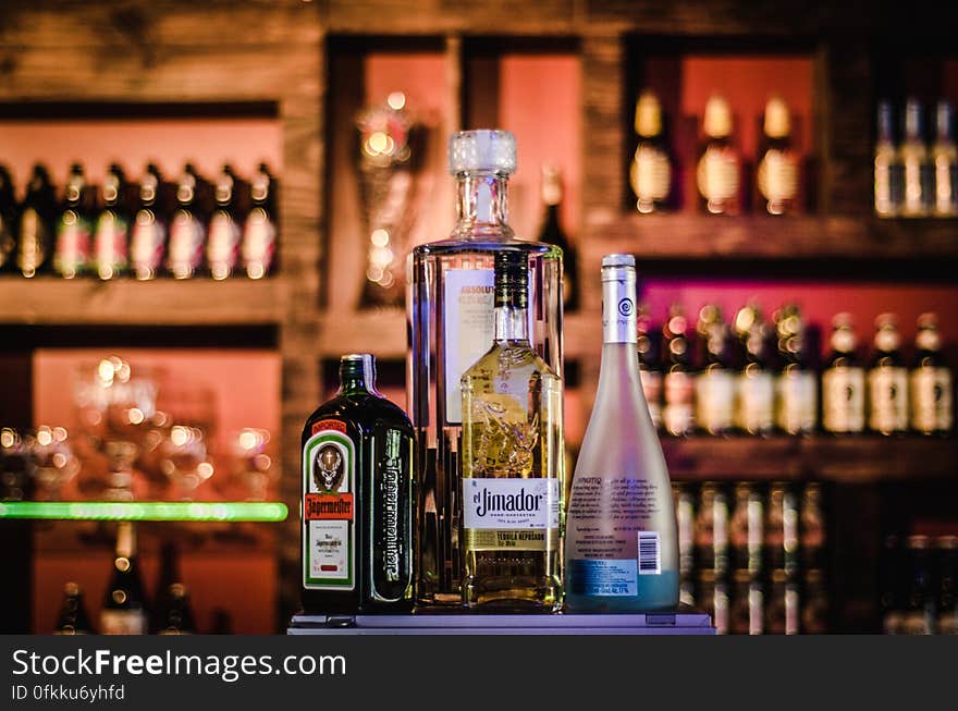 A bar with various bottles of alcoholic drinks. A bar with various bottles of alcoholic drinks.