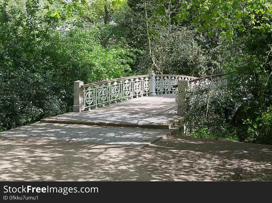 Humpback bridge wooden walkway on metallic structure in a city park. Humpback bridge wooden walkway on metallic structure in a city park