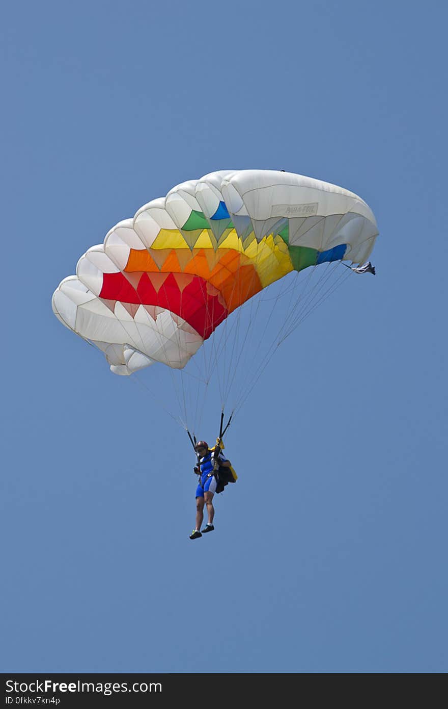 Woman parachutist performing at an aerial show.