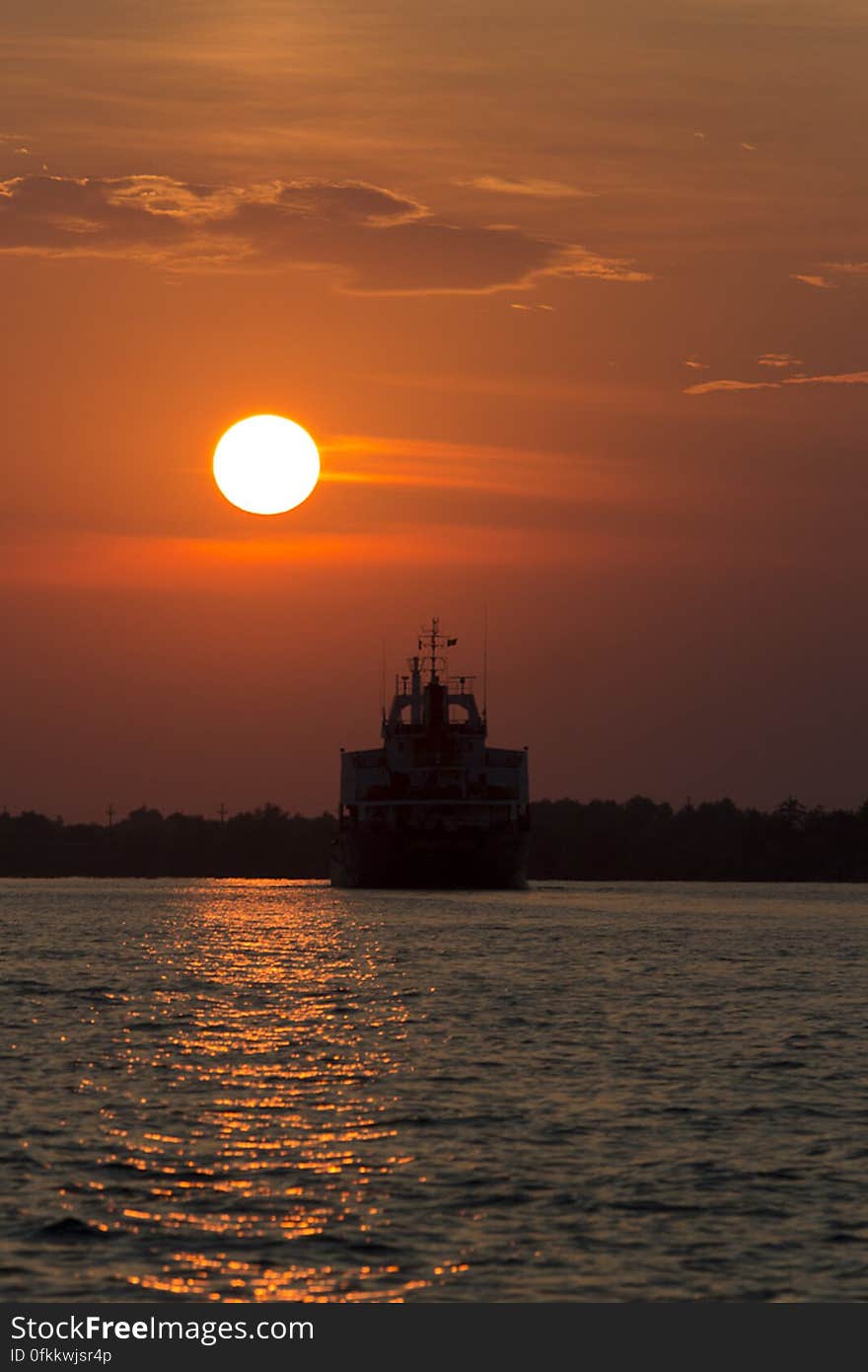 Large transport vessel sailing under sunset light on Danube. Large transport vessel sailing under sunset light on Danube