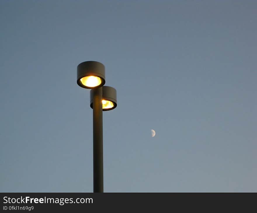 twin-lamp-post-and-half-moon-in-the-background