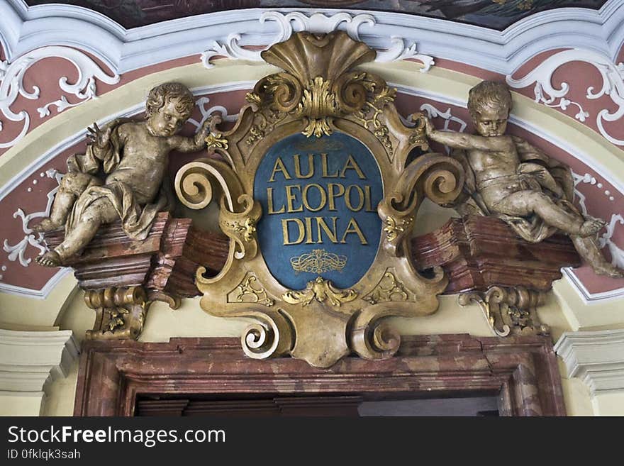 Golden emblem and putto above Aula Leopoldina entrance in Wroclaw University. Golden emblem and putto above Aula Leopoldina entrance in Wroclaw University