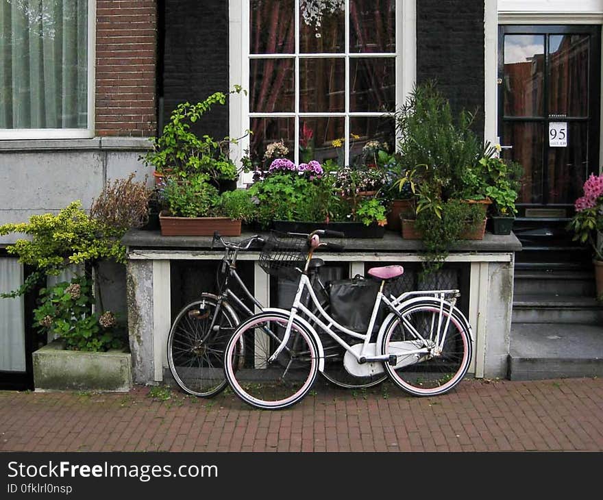 His and hers bicycles parked outside an Amsterdam house. His and hers bicycles parked outside an Amsterdam house.