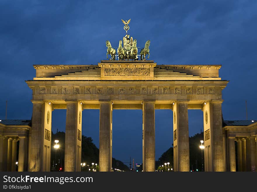 Brandenburg Gate is a former Berlin city gate inspired by the greek Propylea hall, with doric columns and quadriga depicting Victoria riding a four hourse chari