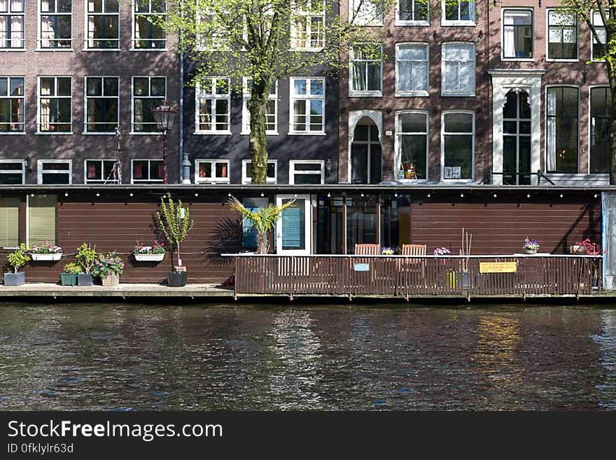 A water home unlike the more common houseboats on a quiet Jordaan district canal in Amsterdam. A water home unlike the more common houseboats on a quiet Jordaan district canal in Amsterdam