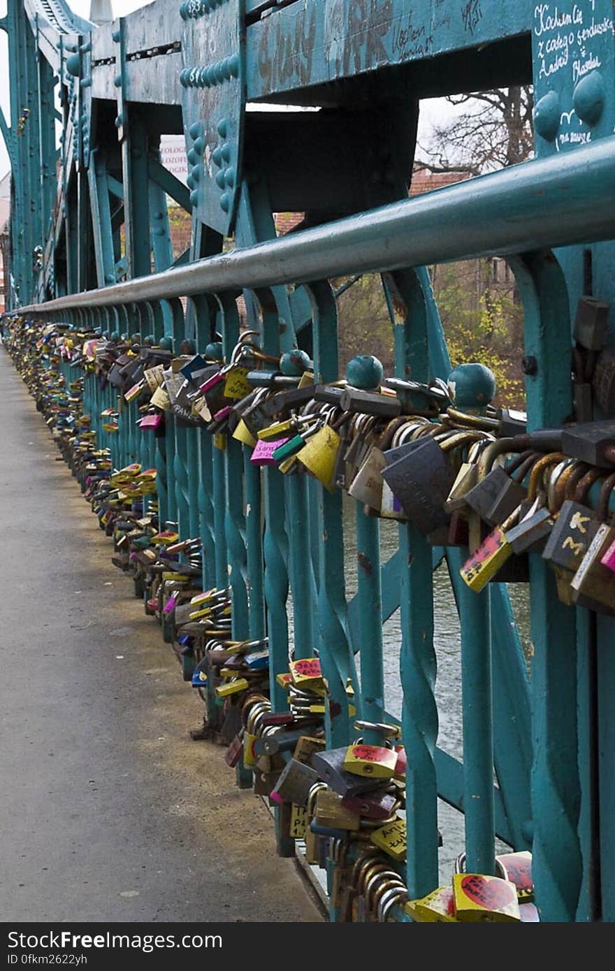 Tradition asks lovers to lock padlocks on Tumski Bridge in Wroclaw and throw the key in Odra river under the bridge.