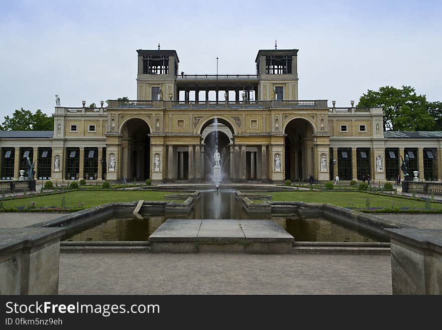 Overview of the Orangery Palace main entrance with the statue of its commisioner Frederick William IV in fron of the peristyle. Overview of the Orangery Palace main entrance with the statue of its commisioner Frederick William IV in fron of the peristyle.