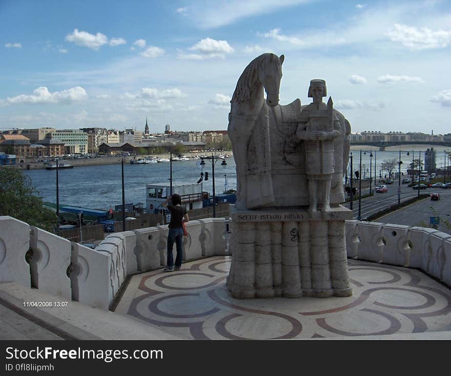 Lisbon city in Portugal looking across Tagus river with statue in foreground.