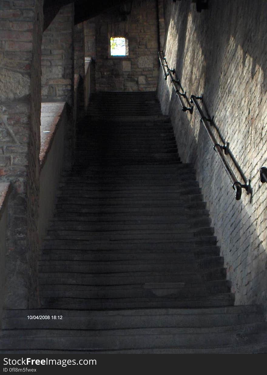 A steep flight of stairs inside a stone building.