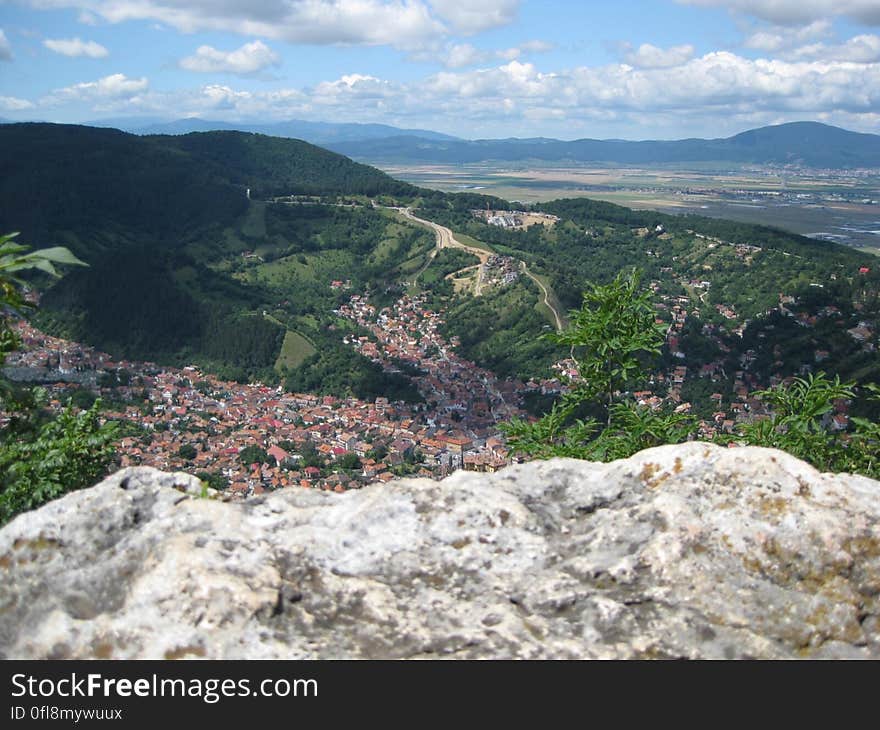 Village nestled in mountainous landscape with cloudscape background. Village nestled in mountainous landscape with cloudscape background.