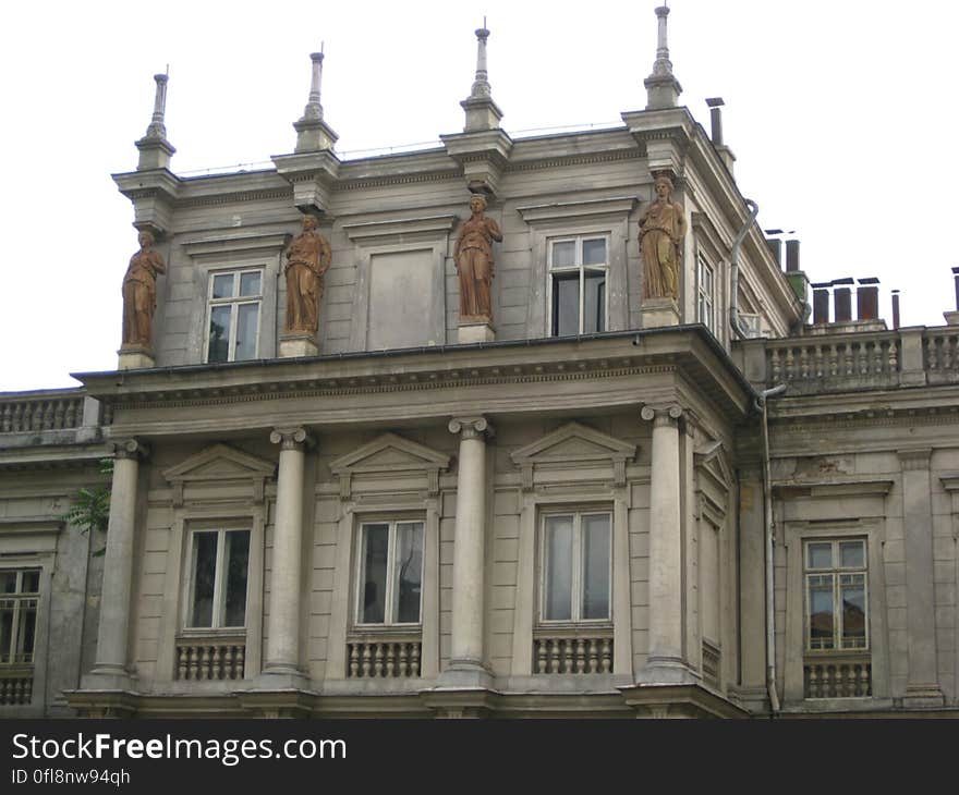 Exterior of a historic building with four statues. Exterior of a historic building with four statues.