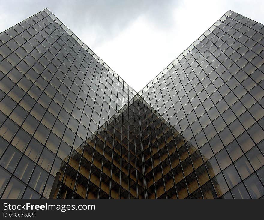 Two identical modern office buildings with glass facades.