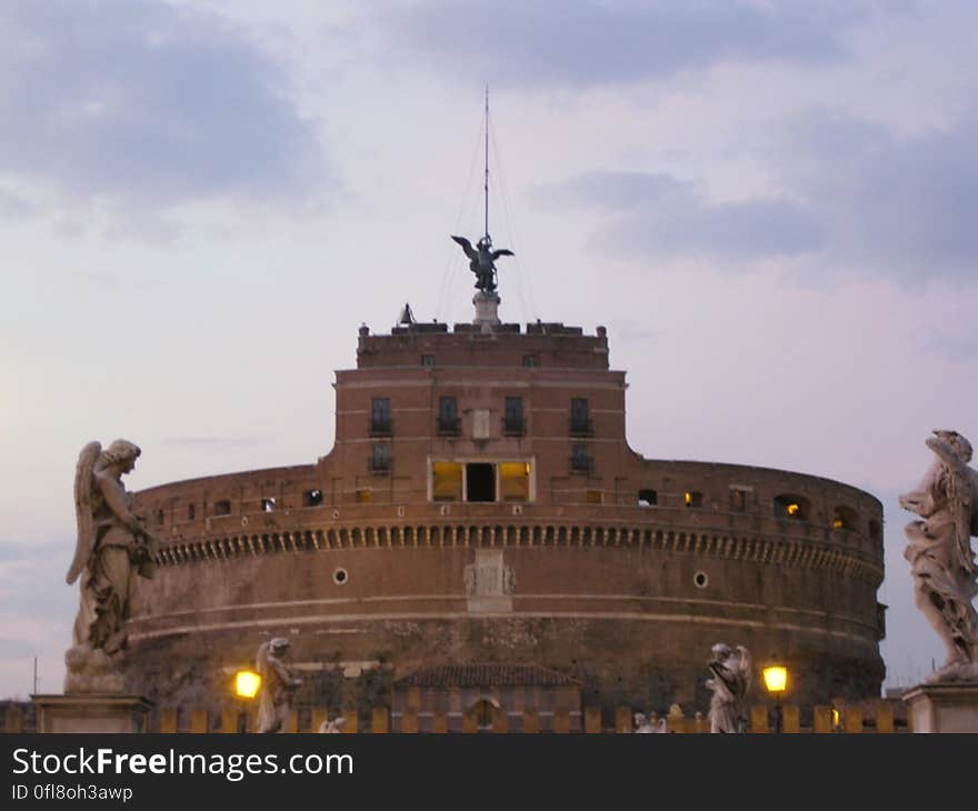 Historic round tower buildings with statues in foreground. Historic round tower buildings with statues in foreground.