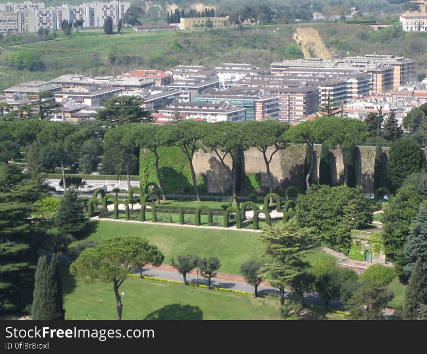 Aerial view of park in city with buildings in background.