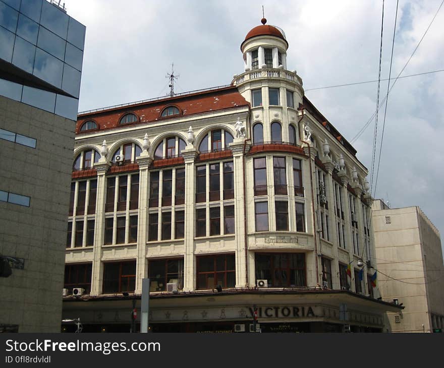 Old buildings next to modern ones in a city with overhead cables. Old buildings next to modern ones in a city with overhead cables.