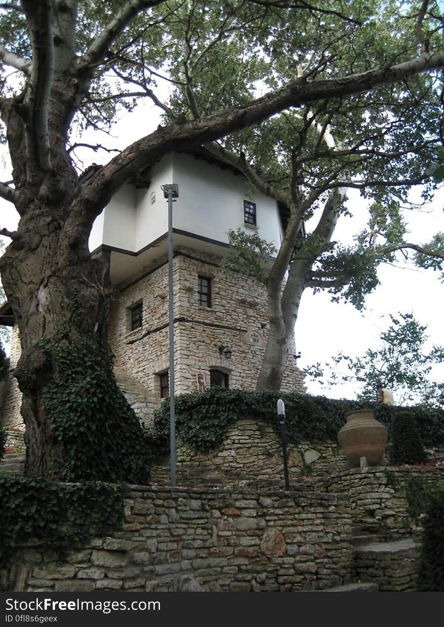 A garden and a building made of stone. A garden and a building made of stone.