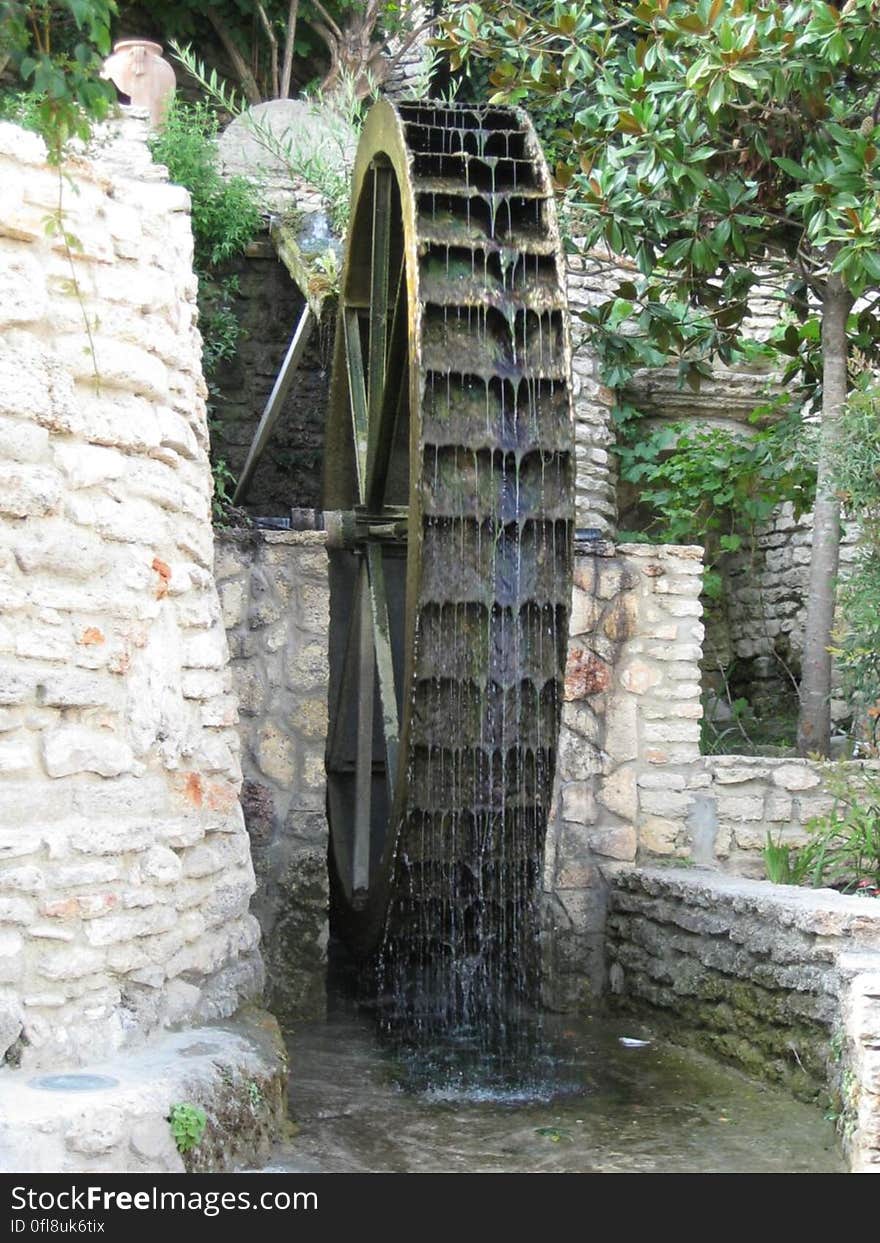 An old mill with a water wheel. An old mill with a water wheel.