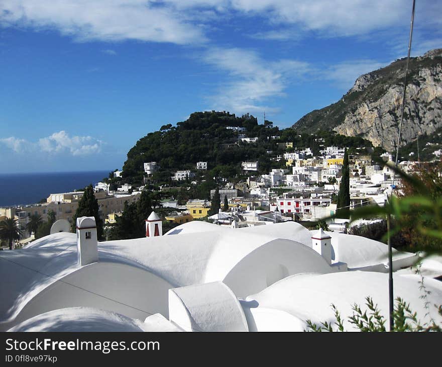 A view over the rooftops of a town on the coast of the Mediterranean sea. A view over the rooftops of a town on the coast of the Mediterranean sea.