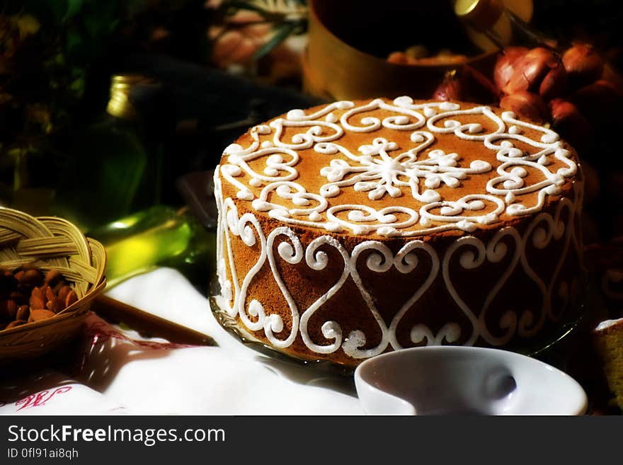 Brown Cake in Front of White Ceramic Bowl