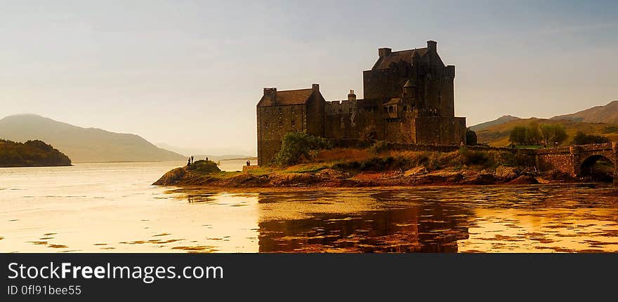 Exterior of ancient castle on lakefront reflecting at dusk. Exterior of ancient castle on lakefront reflecting at dusk.