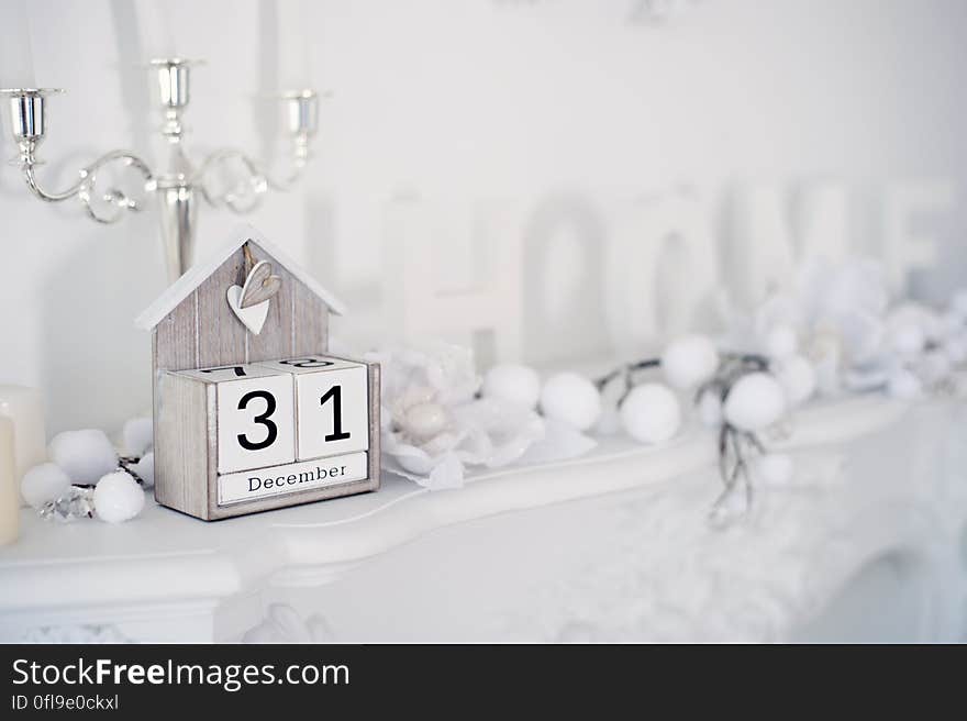 New Years Eve decorations on mantelpiece in home with retro calendar showing date. New Years Eve decorations on mantelpiece in home with retro calendar showing date.