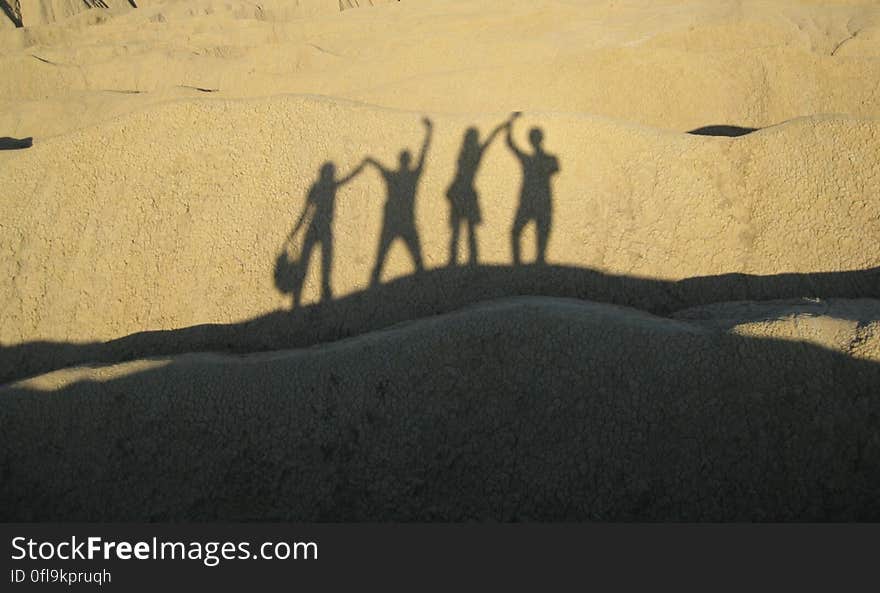 The shadows of happy people on a sand dune. The shadows of happy people on a sand dune.