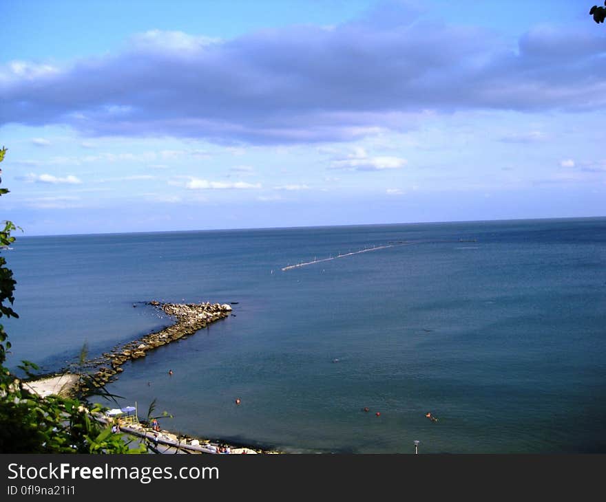 A panoramic view of a beach and open sea in the background.