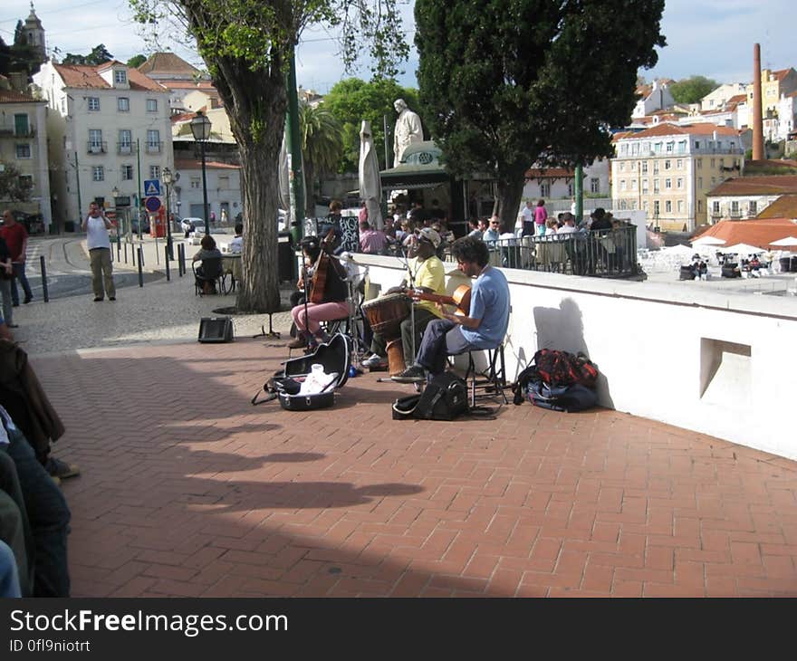 A group of street musicians playing for the people in the city.