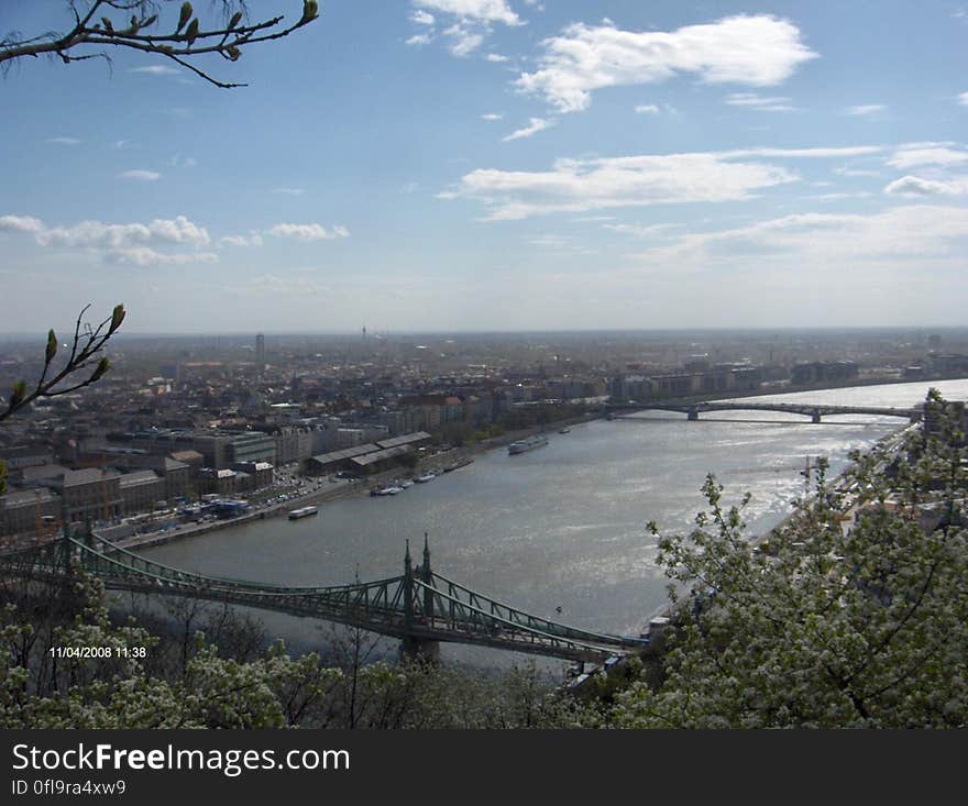 A panoramic view of a river flowing through a city and the bridges across it. A panoramic view of a river flowing through a city and the bridges across it.