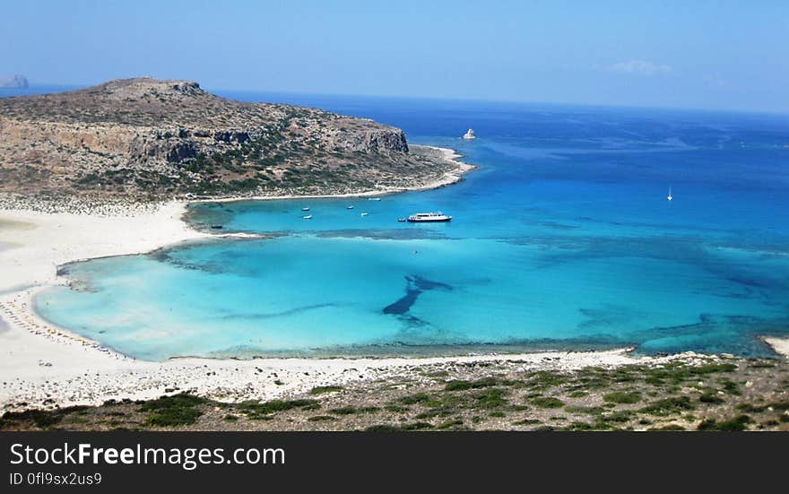 A bay and sandy beach with clear blue waters. A bay and sandy beach with clear blue waters.