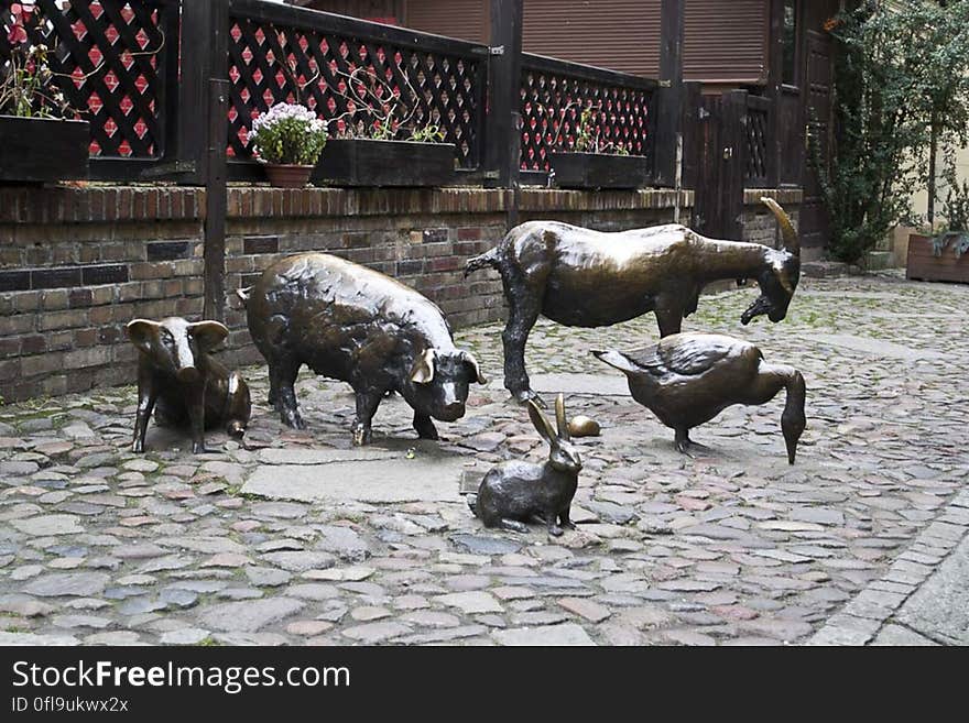 Monument to farm animals in statuary on cobblestone street of Jatki, Poland. Monument to farm animals in statuary on cobblestone street of Jatki, Poland.