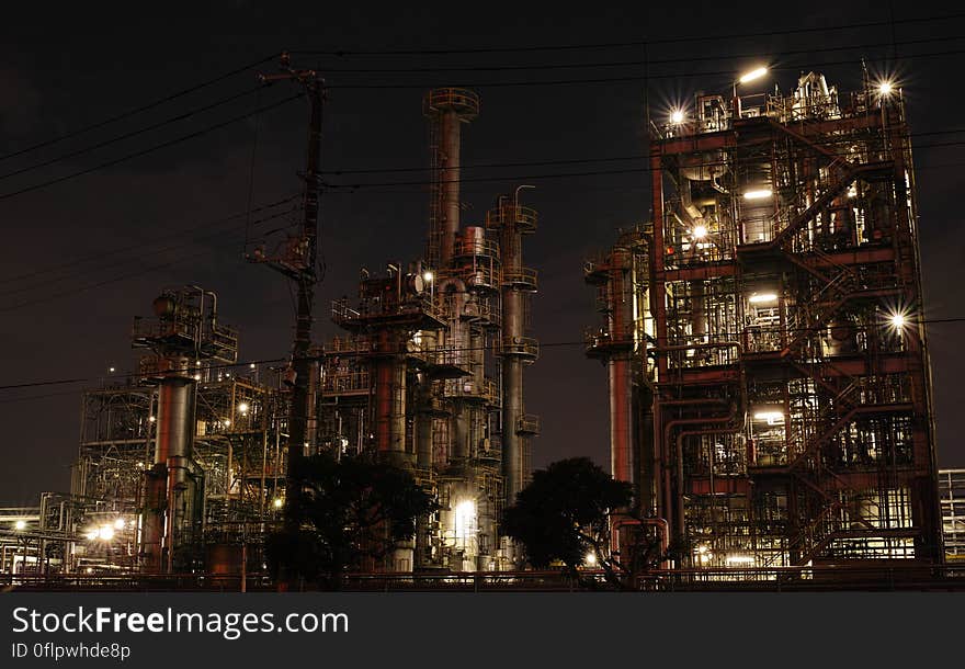 Exterior of modern steel factory illuminated at night. Exterior of modern steel factory illuminated at night.