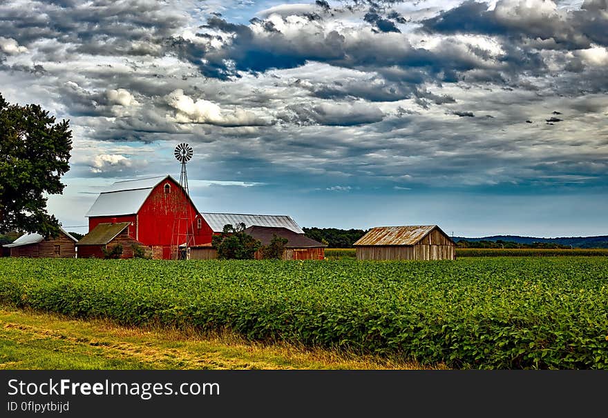 Houses in Farm Against Cloudy Sky